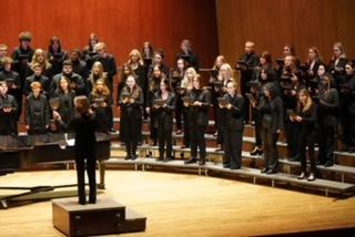 group of students singing on stage