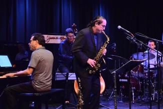 Members of the Osland-Daley jazztet perform onstage holding their instruments