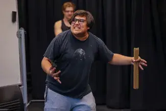A student rehearses in the black box theatre for the fall touring company show