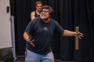 A student rehearses in the black box theatre for the fall touring company show