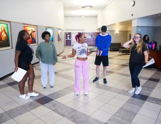 Students in the lobby of the fine arts building rehearsing for the fall touring company