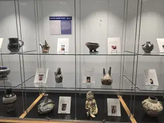 close up of ceramics pieces on display in glass case
