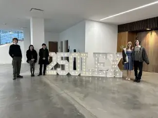 Students from the SAVS Public Art class pose in front of the 250Lex sign