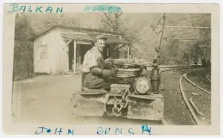 black and white photo of man on farm