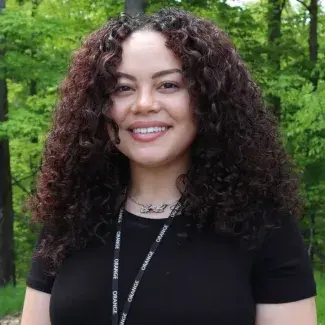 Destyni Green headshot in front of green trees