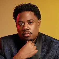 keymon murrah headshot on gold background