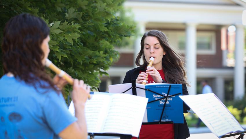 people playing recorders outside