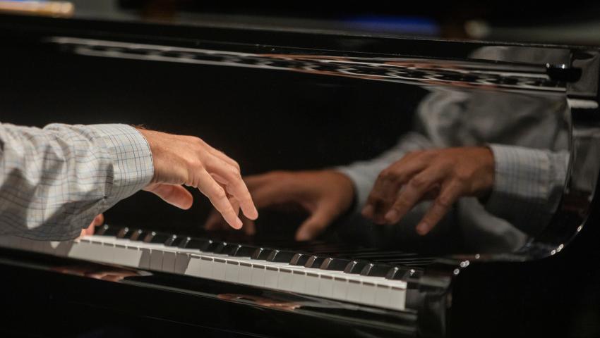 close up of hands on piano