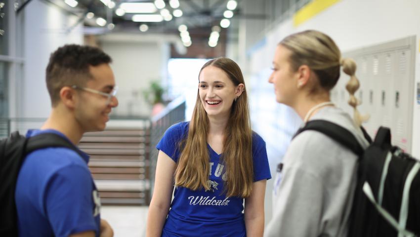 Three students in a hallway