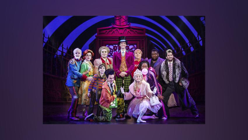 Production still of Charle and the Chocolate Factory with cast onstage posed in bright costumes