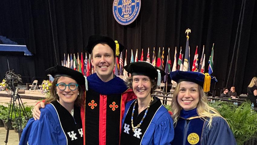 people in doctoral robes at commencement ceremony