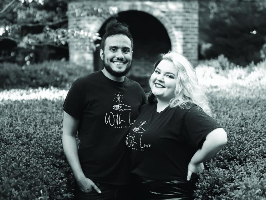 Tommy Townsend and Alexandra Burns post together wearing tshirts with the With Love business logo, black and white photo