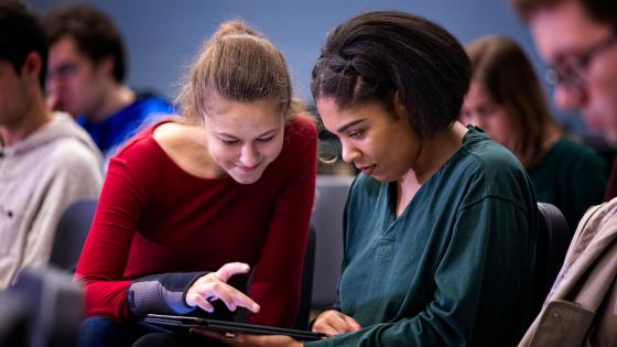 two students looking at ipad