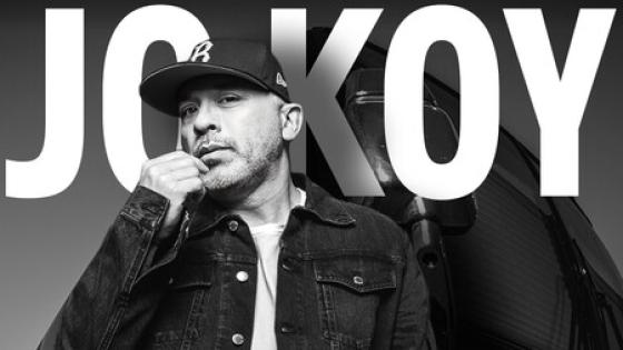 Person in front of JO KOY in black and white