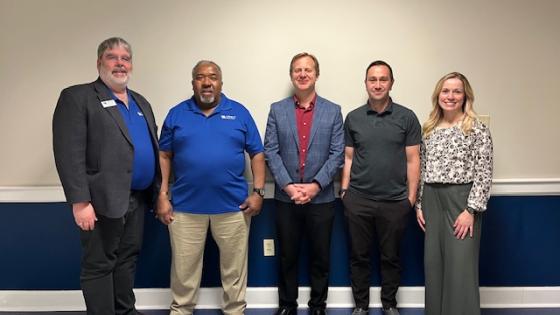 five people facing camera for emerging leaders program group photo