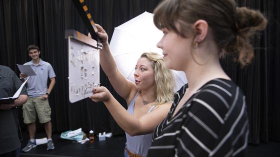 two students in film studio with clicker