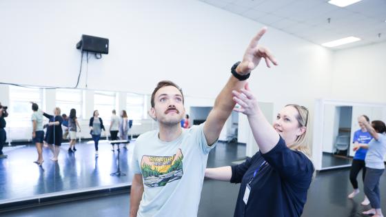 person holding someone's hand into point reaching up