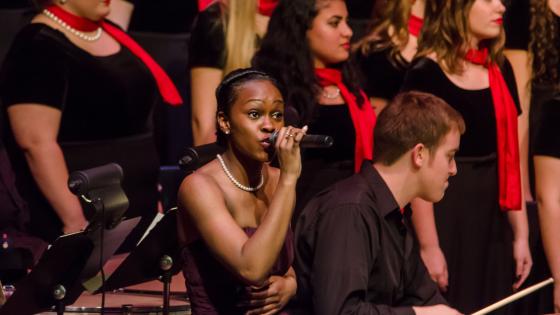 students singing with red scarf