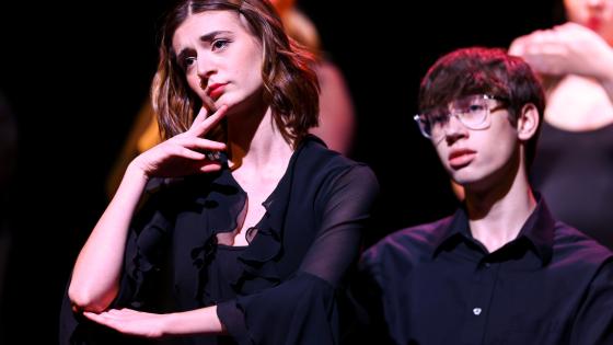 two actors in black on stage
