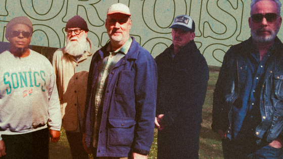 Five excellent musicians stand in front of the word Tortoise