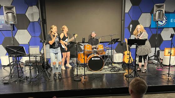 people on stage playing instruments in band