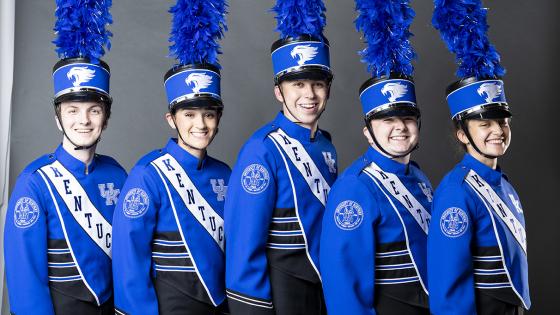 five people in line with blue band uniforms