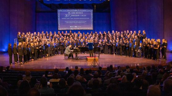 singers on stage with pianist at piano center downstage
