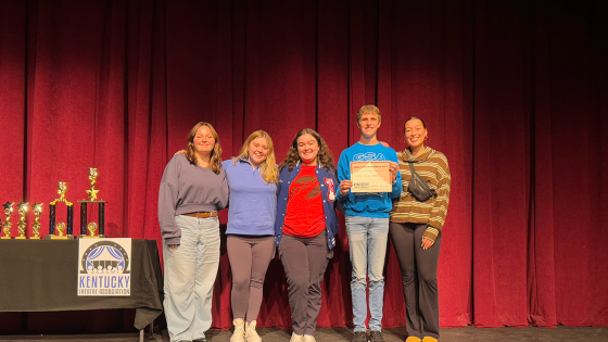 student winners at 2024 kentucky theatre association conference on stage in front of trophies