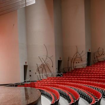Stage right view of the stage and front rows of seats in the Concert Hall at the Singletary Center.