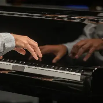 close up of hands on piano