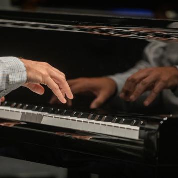 close up of hands on piano