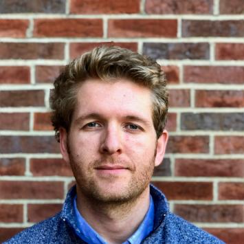 headshot of david crossen against brick wall