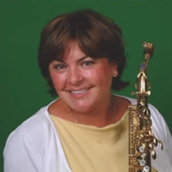 headshot of lisa osland with saxophone on green background