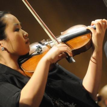 student playing violin in profile