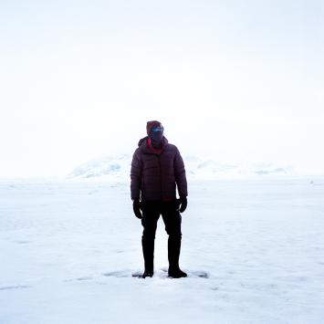 Person standing on snowy arctic background