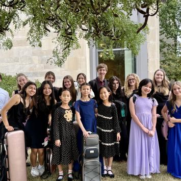 group of viola students posing for camera outside