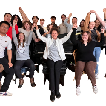 Irina Voro and students with arms raised