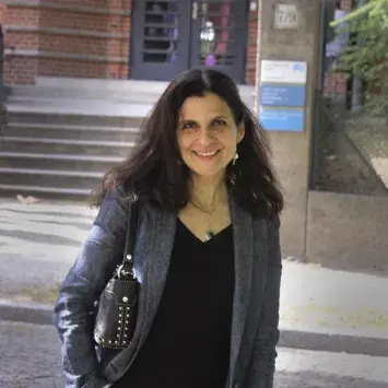Photograph of Laura Katzman outdoors wearing dark clothes with grey blazer