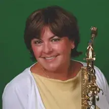 headshot of lisa osland with saxophone on green background